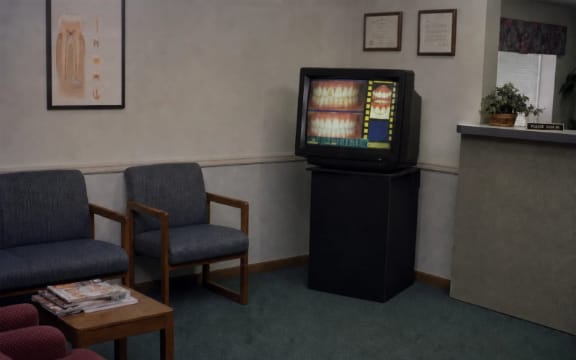 Showcase patient-education presentation playing on a television in a dental reception area